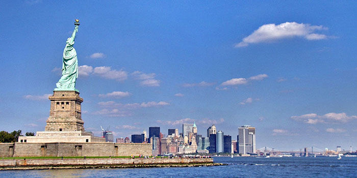 The Statue of Liberty standing against the background of Manhatton